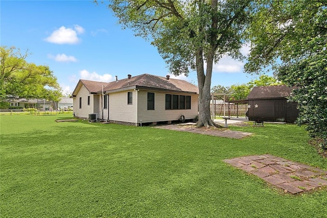 back of house with a lawn, central AC unit, fence, and a patio