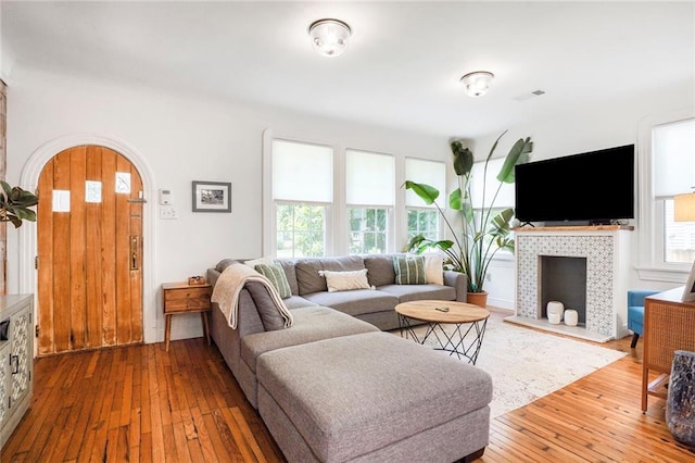 5839 Vicksburg St, New Orleans, LA 70124 - living room with hardwood / wood-style floors, arched walkways, a fireplace, and a healthy amount of sunlight