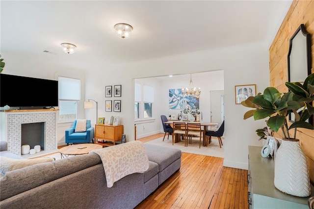 5839 Vicksburg St, New Orleans, LA 70124 - living area featuring light wood-style flooring, visible vents, baseboards, and an inviting chandelier