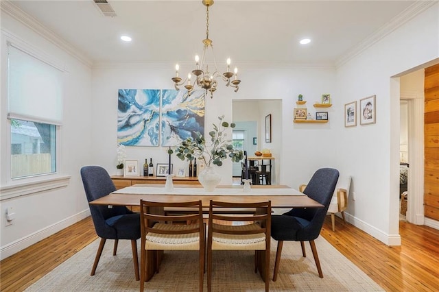 5839 Vicksburg St, New Orleans, LA 70124 - dining space with visible vents, an inviting chandelier, light wood-style floors, and ornamental molding