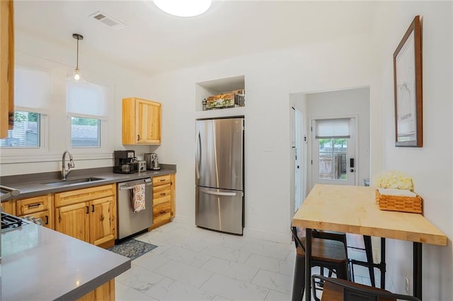 5839 Vicksburg St, New Orleans, LA 70124 - kitchen with a sink, a wealth of natural light, dark countertops, marble finish floor, and appliances with stainless steel finishes