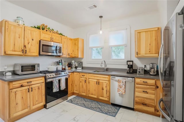5839 Vicksburg St, New Orleans, LA 70124 - kitchen with marble finish floor, a toaster, stainless steel appliances, and a sink