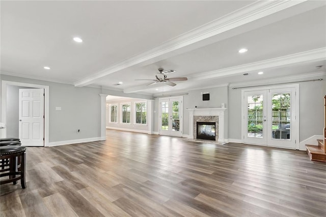 9504 Robin Ln, River Ridge, LA 70123 - living room featuring stairway, crown molding, recessed lighting, wood finished floors, and a high end fireplace