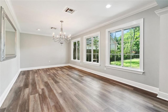 unfurnished dining area with baseboards, wood finished floors, visible vents, and an inviting chandelier