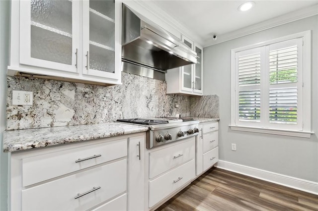 kitchen with stainless steel gas cooktop, dark wood-style flooring, baseboards, backsplash, and wall chimney range hood