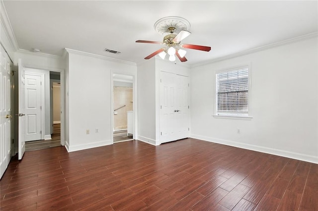unfurnished bedroom featuring wood finished floors, visible vents, baseboards, and ornamental molding