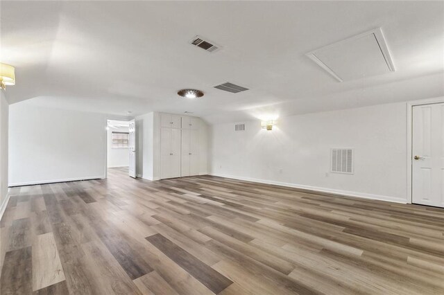 interior space featuring wood finished floors, visible vents, and baseboards