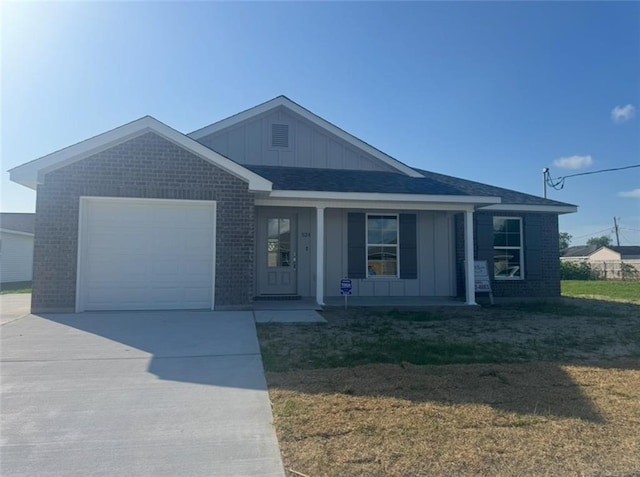 ranch-style home featuring an attached garage, brick siding, board and batten siding, a porch, and driveway