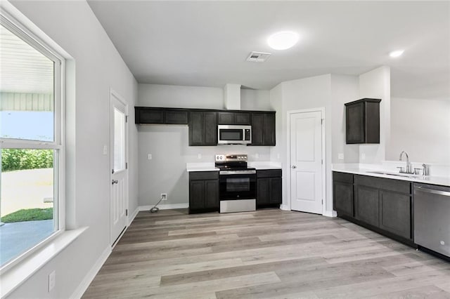 524 Helis Dr, Waggaman, LA 70094 - kitchen with appliances with stainless steel finishes, light countertops, and light wood finished floors