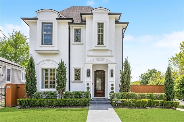 900 French St, New Orleans, LA 70124 - french provincial home with fence, a shingled roof, and a front yard