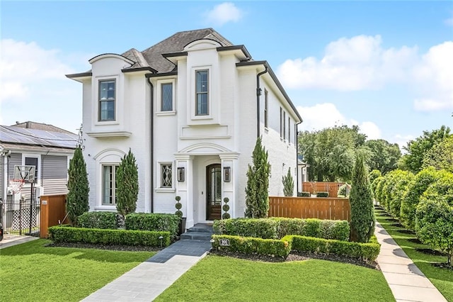 900 French St, New Orleans, LA 70124 - french provincial home featuring a front yard and fence