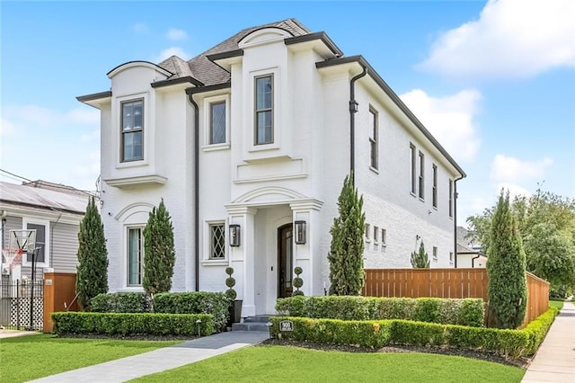 900 French St, New Orleans, LA 70124 - view of front of property with fence, a front lawn, and stucco siding