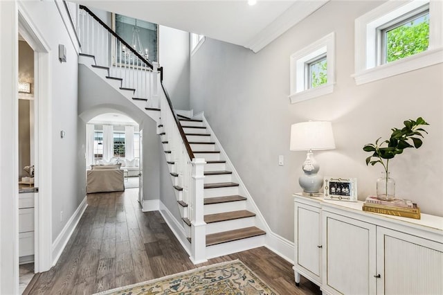 900 French St, New Orleans, LA 70124 - stairs with arched walkways, wood finished floors, and baseboards