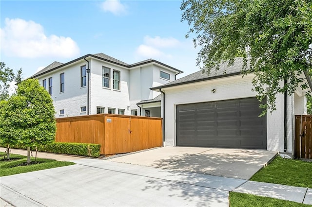 900 French St, New Orleans, LA 70124 - contemporary house featuring a gate, an attached garage, concrete driveway, and fence