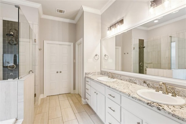full bathroom featuring double vanity, visible vents, a shower stall, and a sink