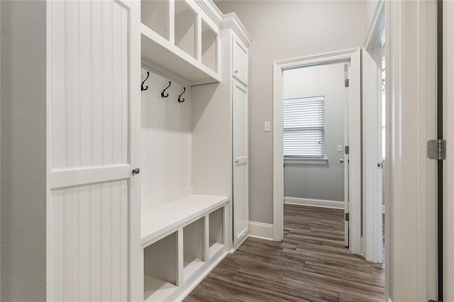 mudroom with baseboards and dark wood-style flooring