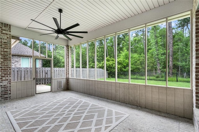 unfurnished sunroom with ceiling fan