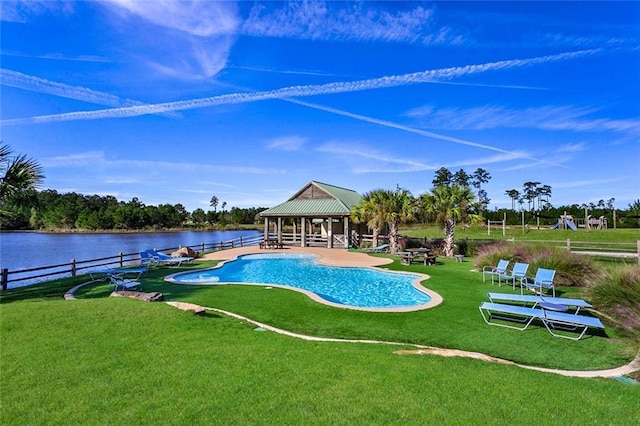 outdoor pool with a gazebo, a patio area, a water view, fence, and a yard