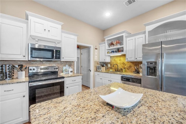 kitchen with open shelves, a sink, white cabinets, appliances with stainless steel finishes, and visible vents