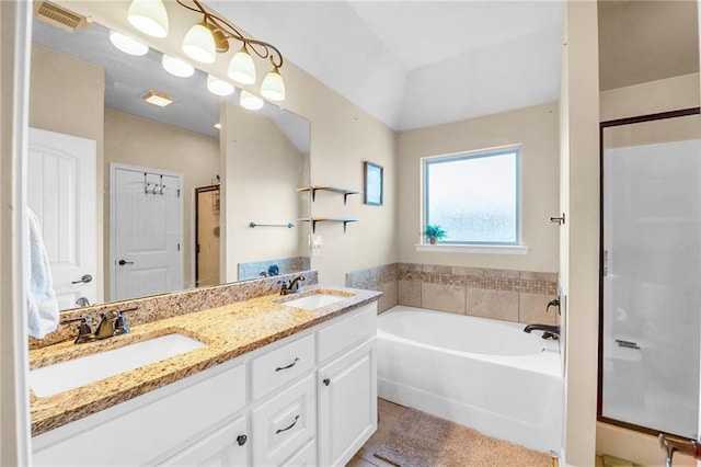 full bath with tile patterned flooring, a garden tub, visible vents, and a sink