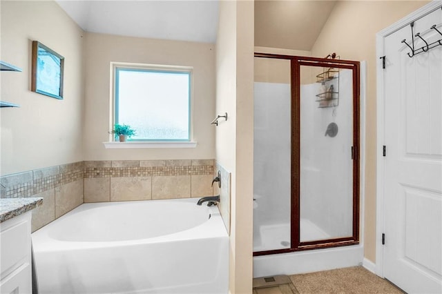 bathroom featuring a shower stall, a garden tub, and vanity