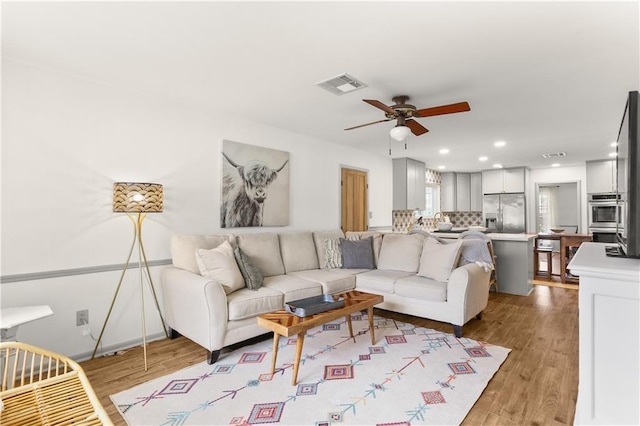4716 Elmwood Pkwy, Metairie, LA 70003 - living area featuring light wood-type flooring, visible vents, recessed lighting, and ceiling fan