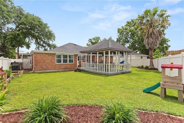 4716 Elmwood Pkwy, Metairie, LA 70003 - rear view of house with a gazebo, a lawn, a fenced backyard, brick siding, and roof with shingles