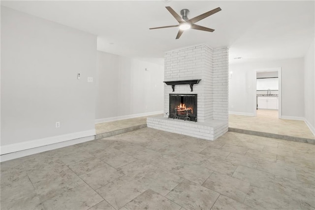 1534 Holiday Pl, New Orleans, LA 70131 - unfurnished living room with a sink, baseboards, a fireplace, and ceiling fan