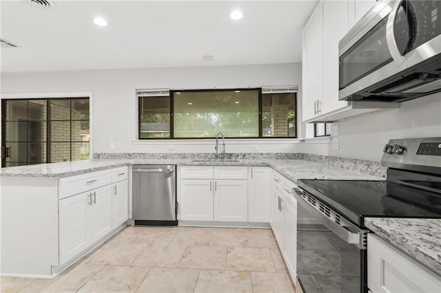1534 Holiday Pl, New Orleans, LA 70131 - kitchen with a peninsula, white cabinets, appliances with stainless steel finishes, and a sink