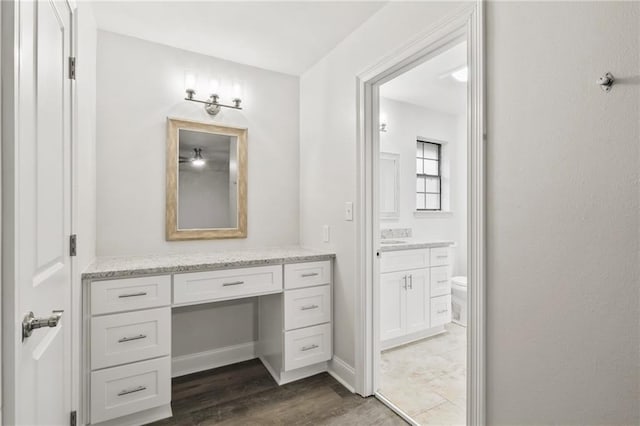 1534 Holiday Pl, New Orleans, LA 70131 - bathroom with baseboards, wood finished floors, toilet, and vanity