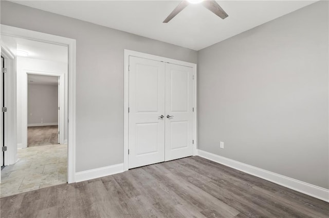 1534 Holiday Pl, New Orleans, LA 70131 - unfurnished bedroom with baseboards, wood finished floors, a closet, and ceiling fan