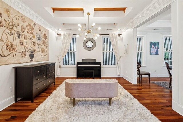 living area with a chandelier, dark wood finished floors, ornamental molding, and coffered ceiling