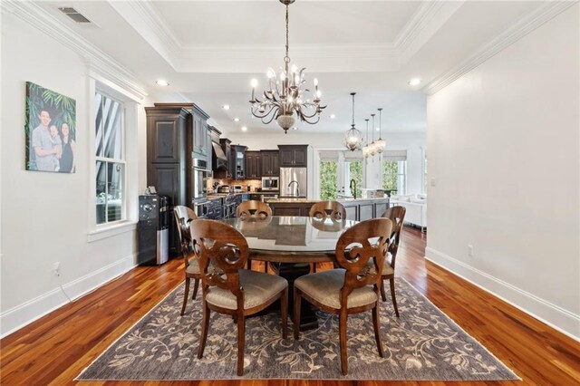 dining area featuring baseboards, recessed lighting, a notable chandelier, and dark wood finished floors