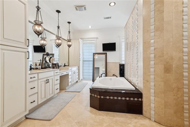 full bathroom featuring a garden tub, visible vents, vanity, and crown molding
