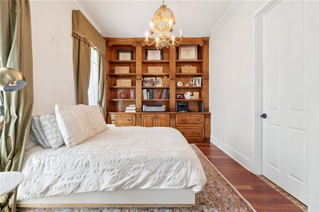 bedroom with baseboards, an inviting chandelier, crown molding, and dark wood-type flooring