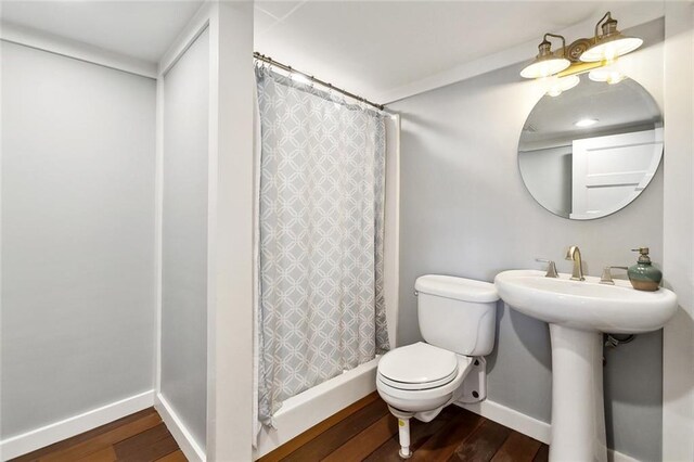 7930 Breakwater Drive 52&53, New Orleans, LA 70124 - bathroom with baseboards, wood finished floors, curtained shower, and toilet