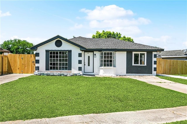 ranch-style home featuring a gate, a shingled roof, a front lawn, and fence