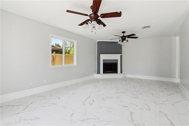 unfurnished living room with baseboards, visible vents, marble finish floor, a large fireplace, and ceiling fan