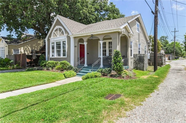 615 Filmore Ave, New Orleans, LA 70124 - view of front of home with a porch, a shingled roof, and stucco siding