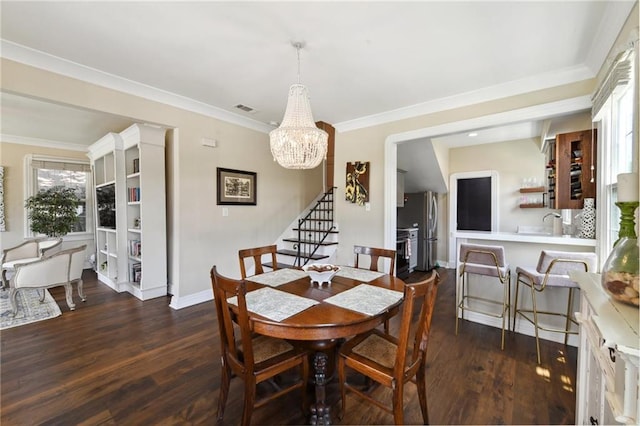 615 Filmore Ave, New Orleans, LA 70124 - dining room with stairs, dark wood-type flooring, a chandelier, and crown molding
