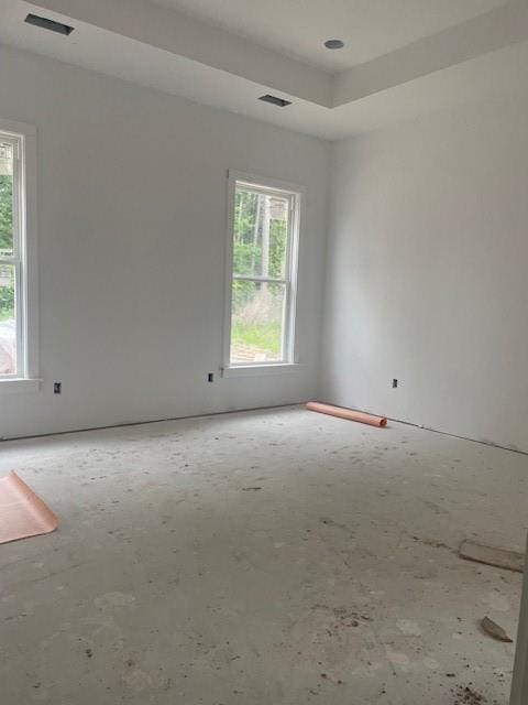 unfurnished room featuring a wealth of natural light and visible vents
