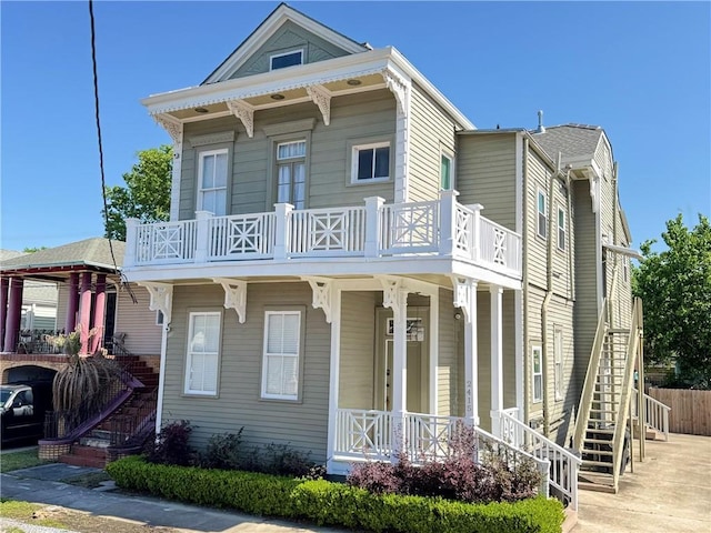 2415 Columbus St, New Orleans, LA 70119 - view of front of house featuring a balcony, a porch, and stairs