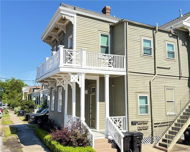 2415 Columbus St, New Orleans, LA 70119 - view of front of home with a chimney and a balcony