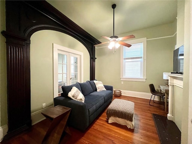 2415 Columbus St, New Orleans, LA 70119 - living area featuring a fireplace with flush hearth, baseboards, a ceiling fan, and wood finished floors