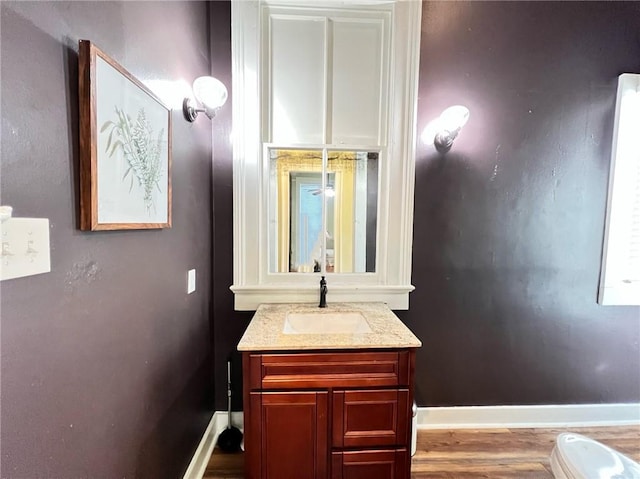 2415 Columbus St, New Orleans, LA 70119 - bathroom with baseboards, vanity, and wood finished floors