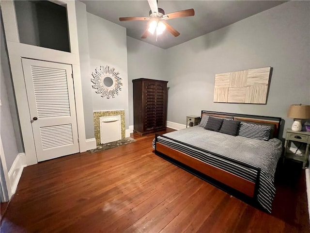 2415 Columbus St, New Orleans, LA 70119 - bedroom with baseboards, a ceiling fan, wood finished floors, and a fireplace