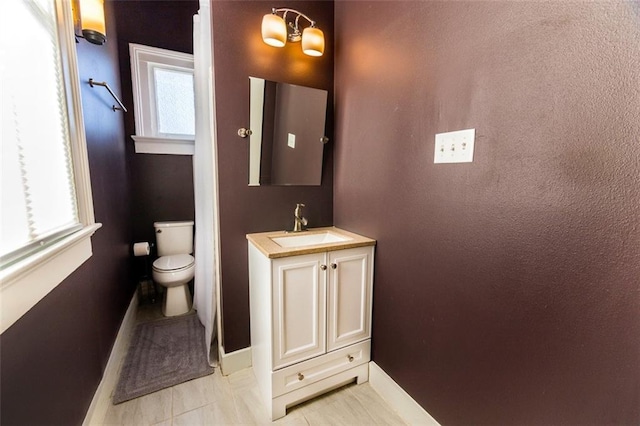 2415 Columbus St, New Orleans, LA 70119 - bathroom with tile patterned floors, baseboards, vanity, and toilet