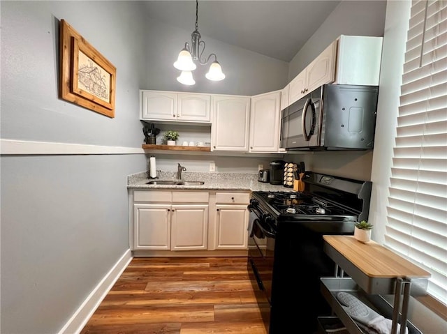 2415 Columbus St, New Orleans, LA 70119 - kitchen with vaulted ceiling, open shelves, wood finished floors, a sink, and black appliances