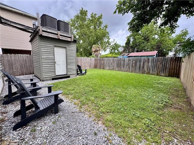 2415 Columbus St, New Orleans, LA 70119 - view of yard with a fenced backyard, an outdoor structure, and a storage unit