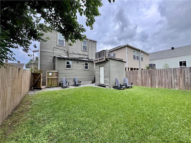 2415 Columbus St, New Orleans, LA 70119 - back of property featuring a gate, a lawn, and a fenced backyard